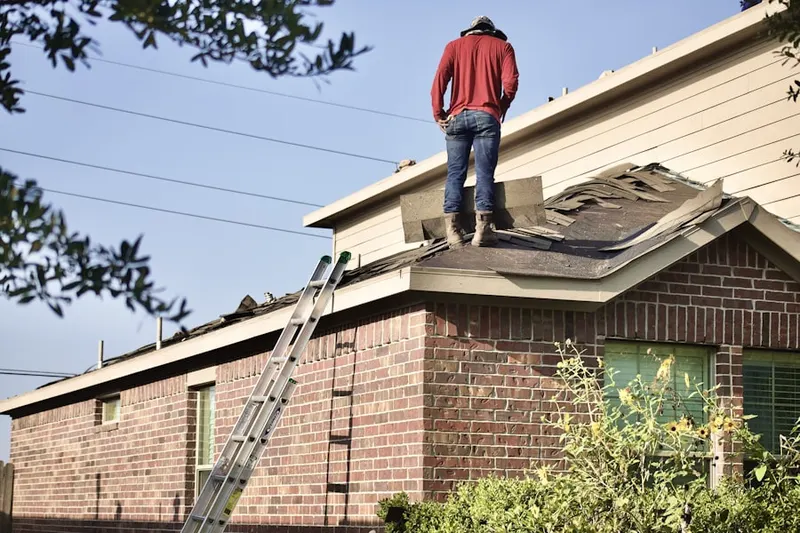 Professional roofer working on a residential roof in Watchung